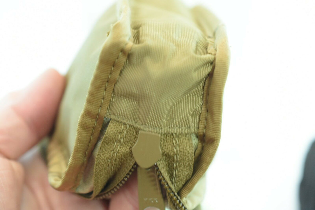 Tan fabric wallet held in hand, showing zippered compartments for While The Cigars Lit WTCL001