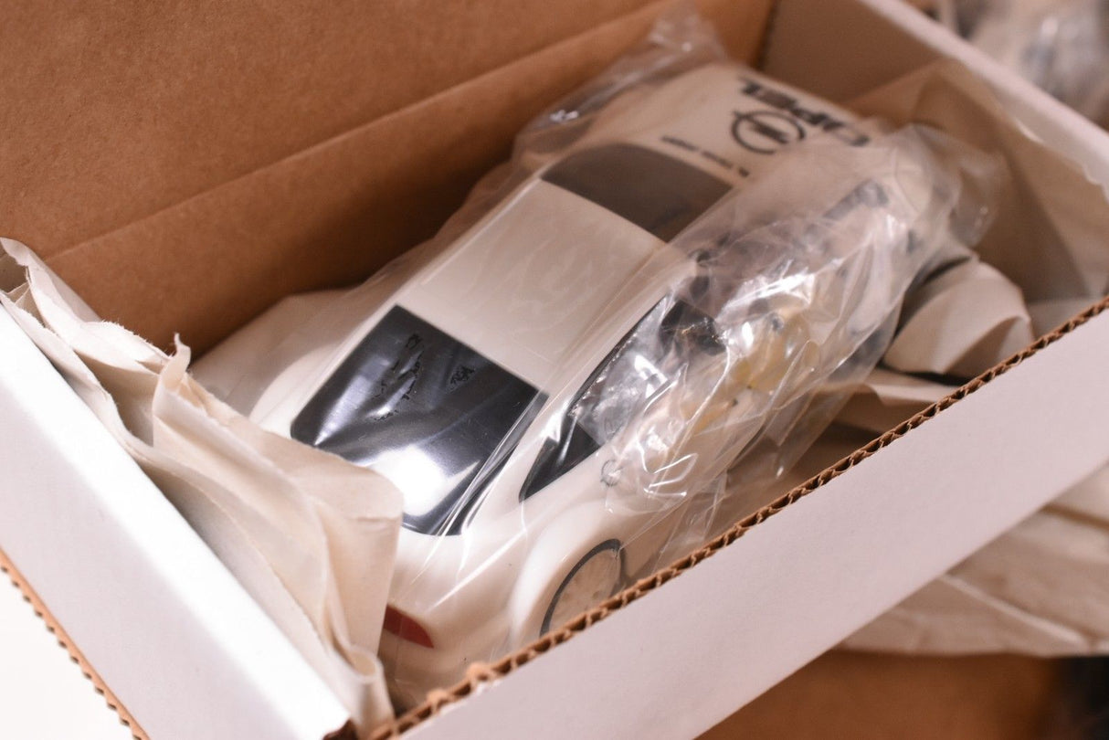 White race car model in open cardboard box for SCX/Scalextric SPA300