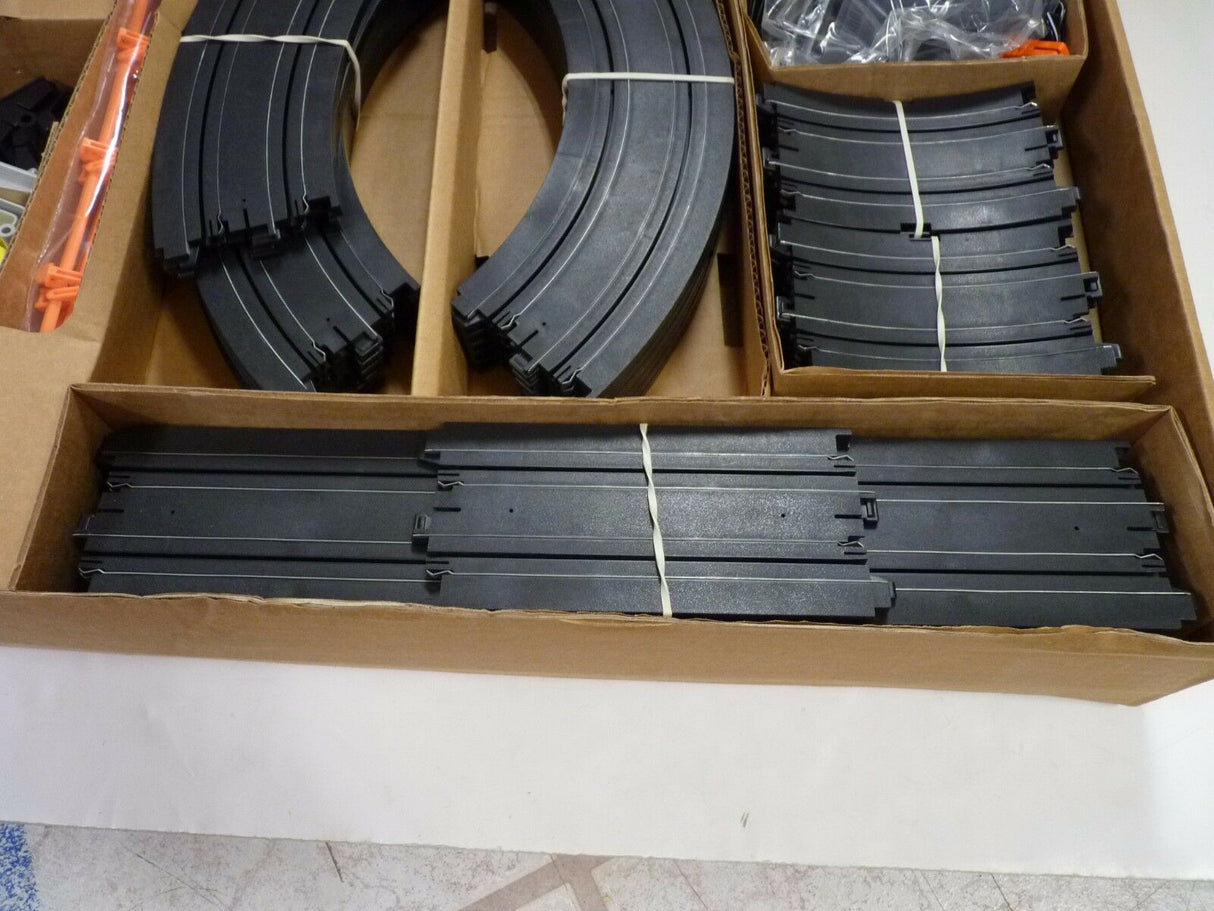 Black model train track pieces in a cardboard box for Aurora / AFX / Tomy 9115M, package view, product view 10