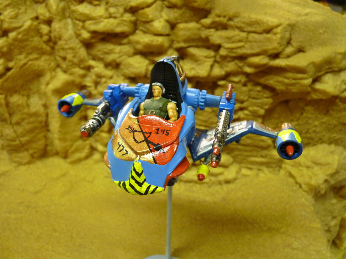 Sci-fi robot vehicle model with blue and yellow accents on a stand for Robogear 6006