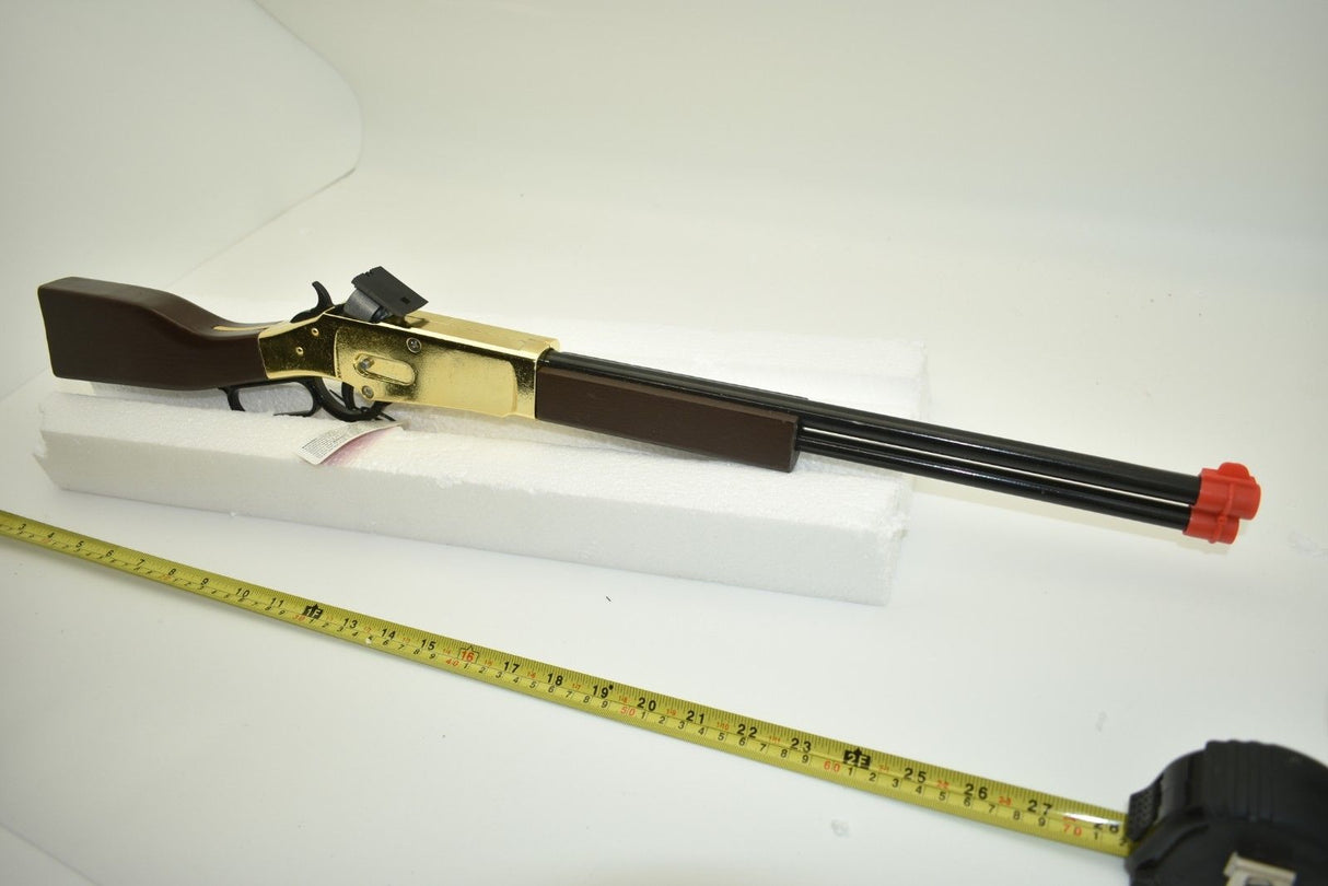 Toy rifle with brown stock and gold accents, laid on white foam next to a ruler for Parris Toys 2703C