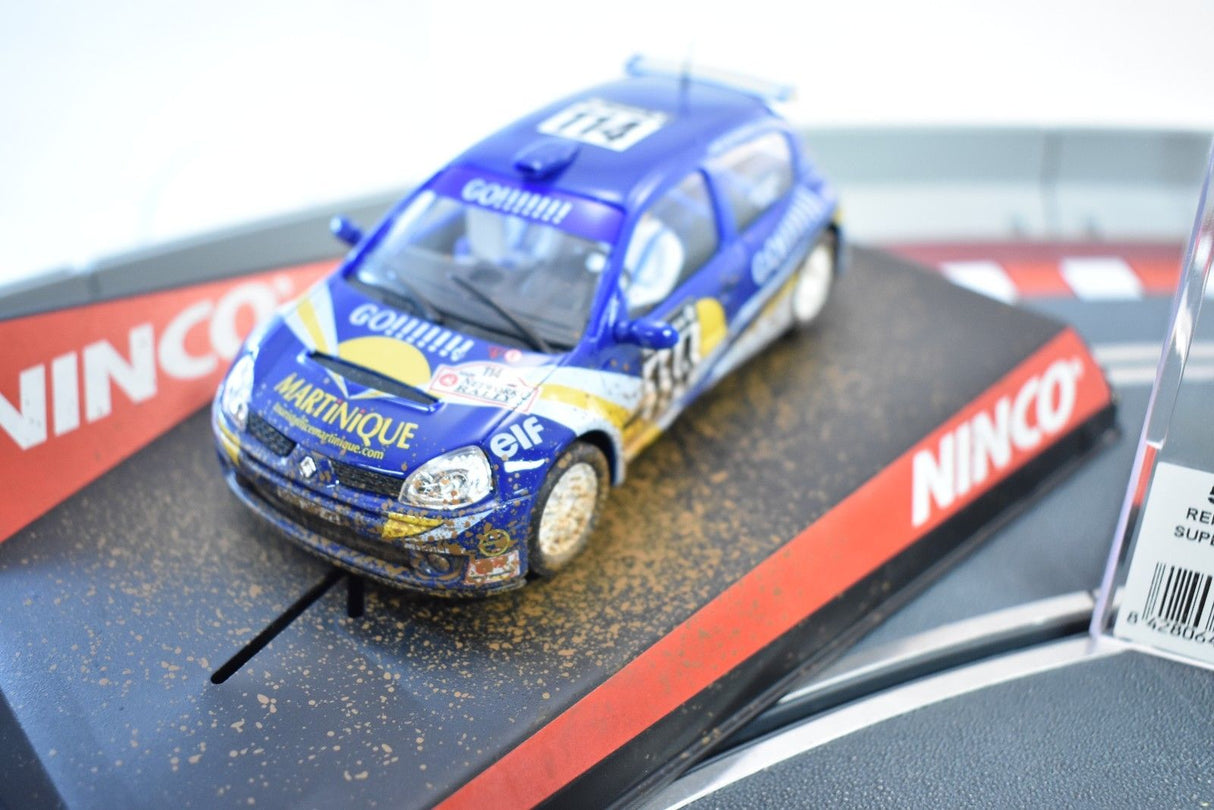 Blue Renault Clio race car with dirt effect on a track base for Ninco 50313