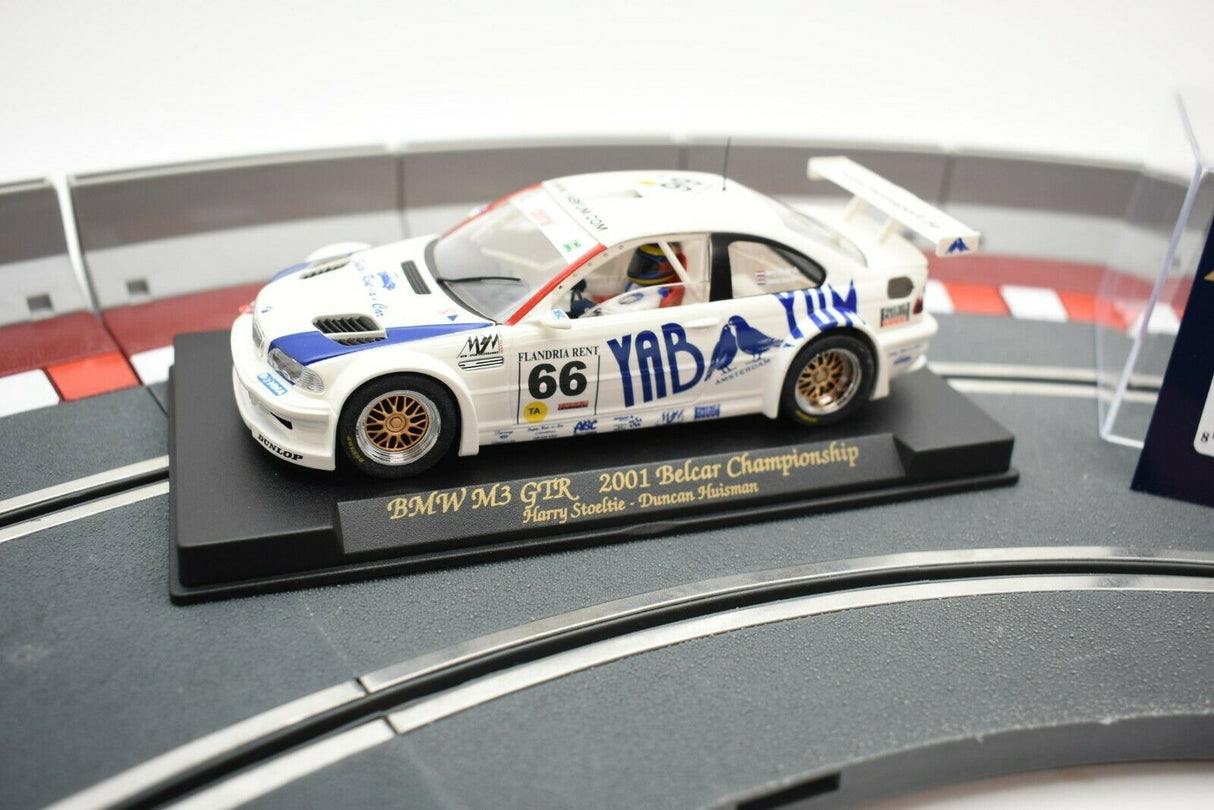 Slot car of a 2001 BMW M3 GTR race car on a display base for Fly Car 88013, rear view