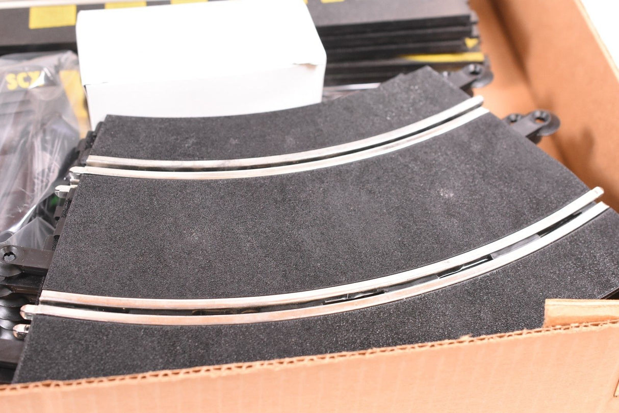 Curved black track sections with silver edges, ready for race setup for SCX/Scalextric SPA300