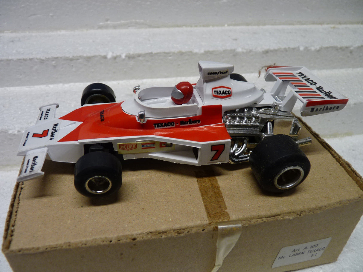 Red and white McLaren race car model on a cardboard box for Polistil Evolution ART A.100
