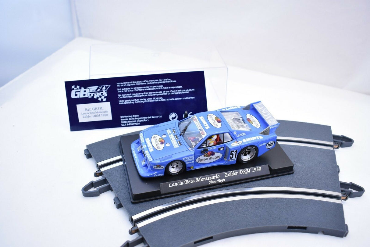 Blue slot car, Lancia Beta Montecarlo Zolder DRM 1980, displayed on a stand for Fly Car GB35L