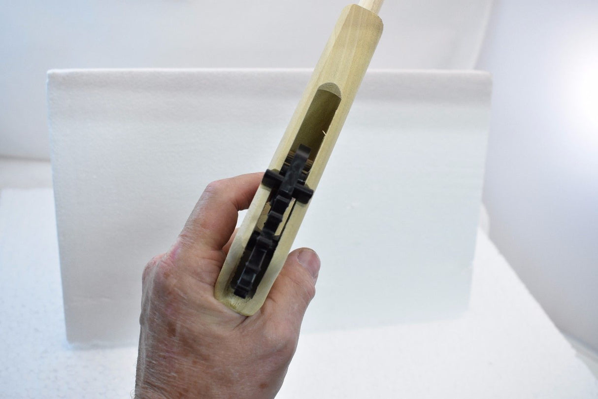 Wooden toy pistol with black firing mechanism held by a hand for Magnum Rubber Band Guns GL2LWMN