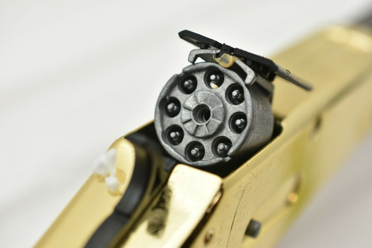 Close-up of a revolver cylinder on a golden rifle replica for Parris Toys 2703C