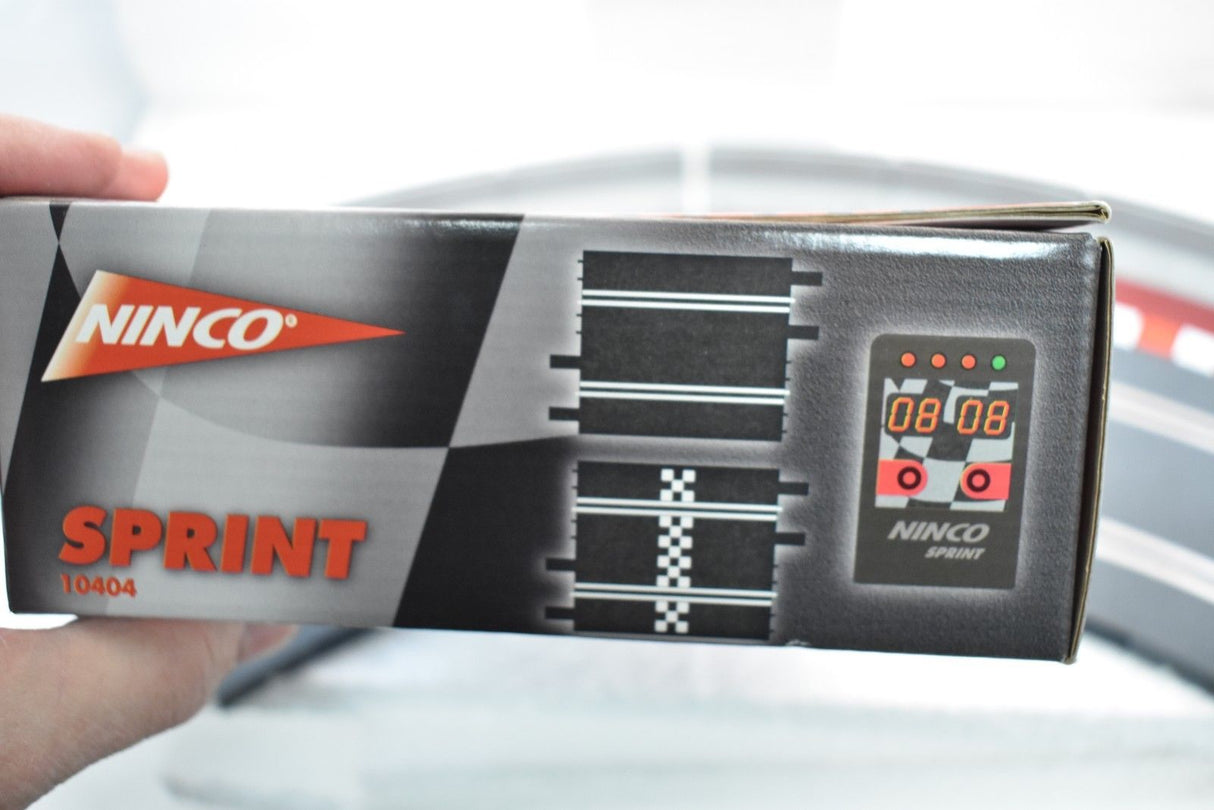 Electronic lap counter box showing "NINCO SPRINT 10404" and a digital display