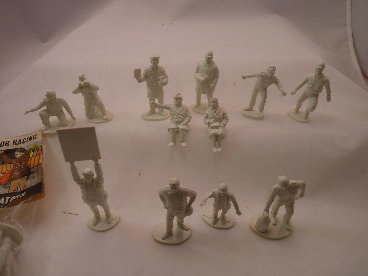 Unpainted plastic figures: racers and spectators for a motor racing diorama for AIRFIX