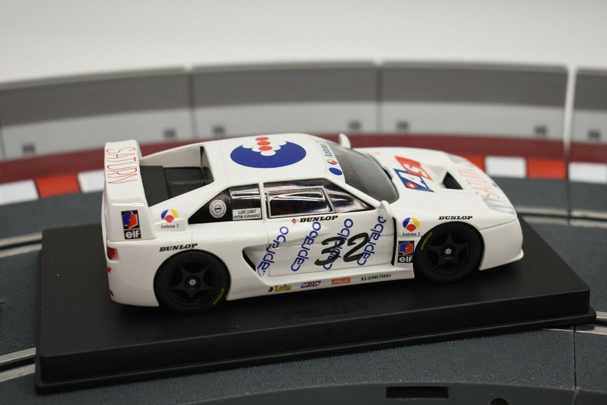 White race car model with blue and red accents, displayed on a black base for Fly Car 88021