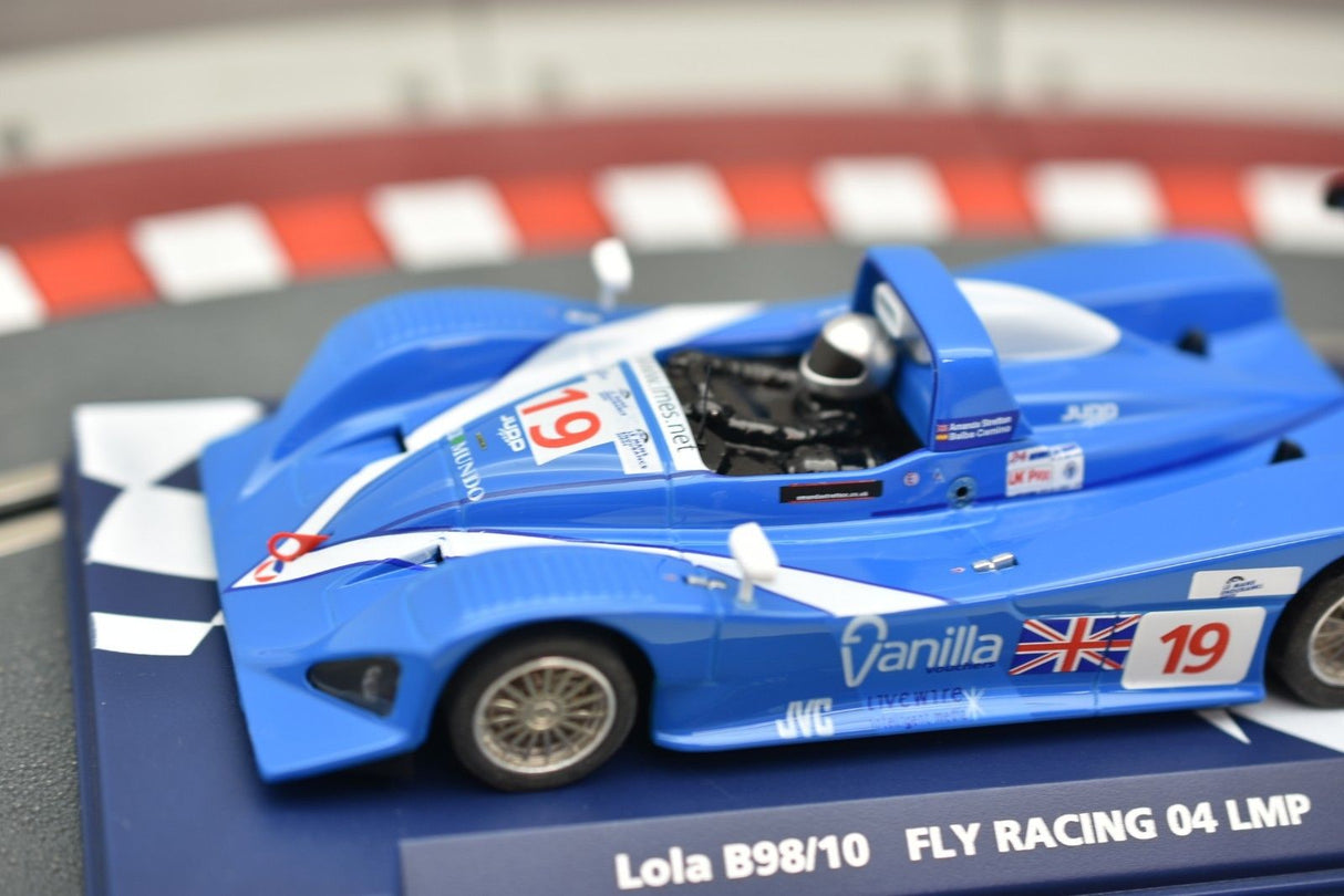 Blue race car model, Lola B98/10, on a display stand for Fly Car 07051