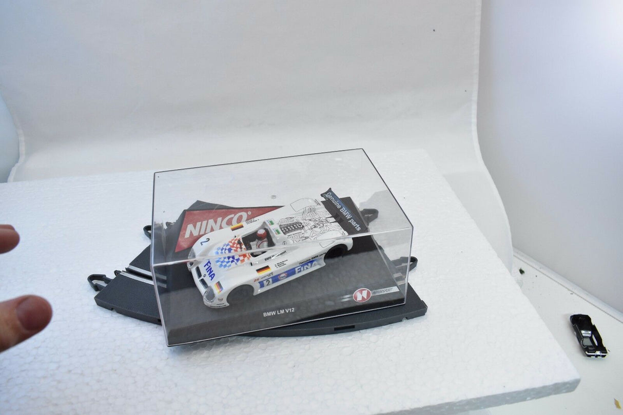 Slot car of a BMW V12 LM race car in a clear display case for Ninco 50193
