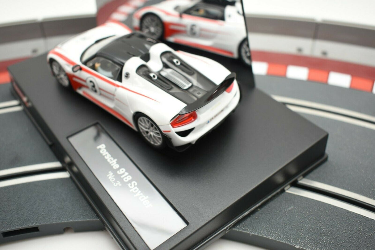 White and black slot car of a Porsche 918 Spyder on a track base for Carrera 48627477