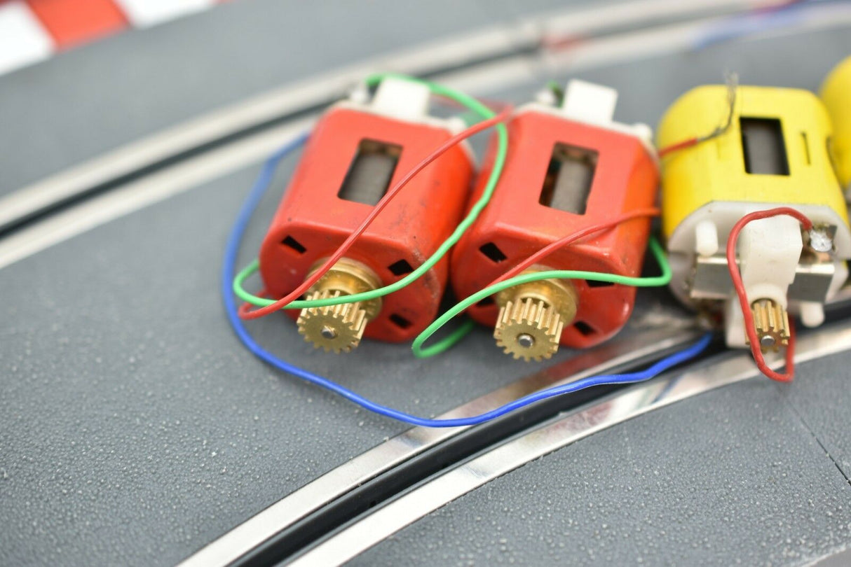Small electric motors with wires laid on a gray surface for Mabuchi 8-Motors