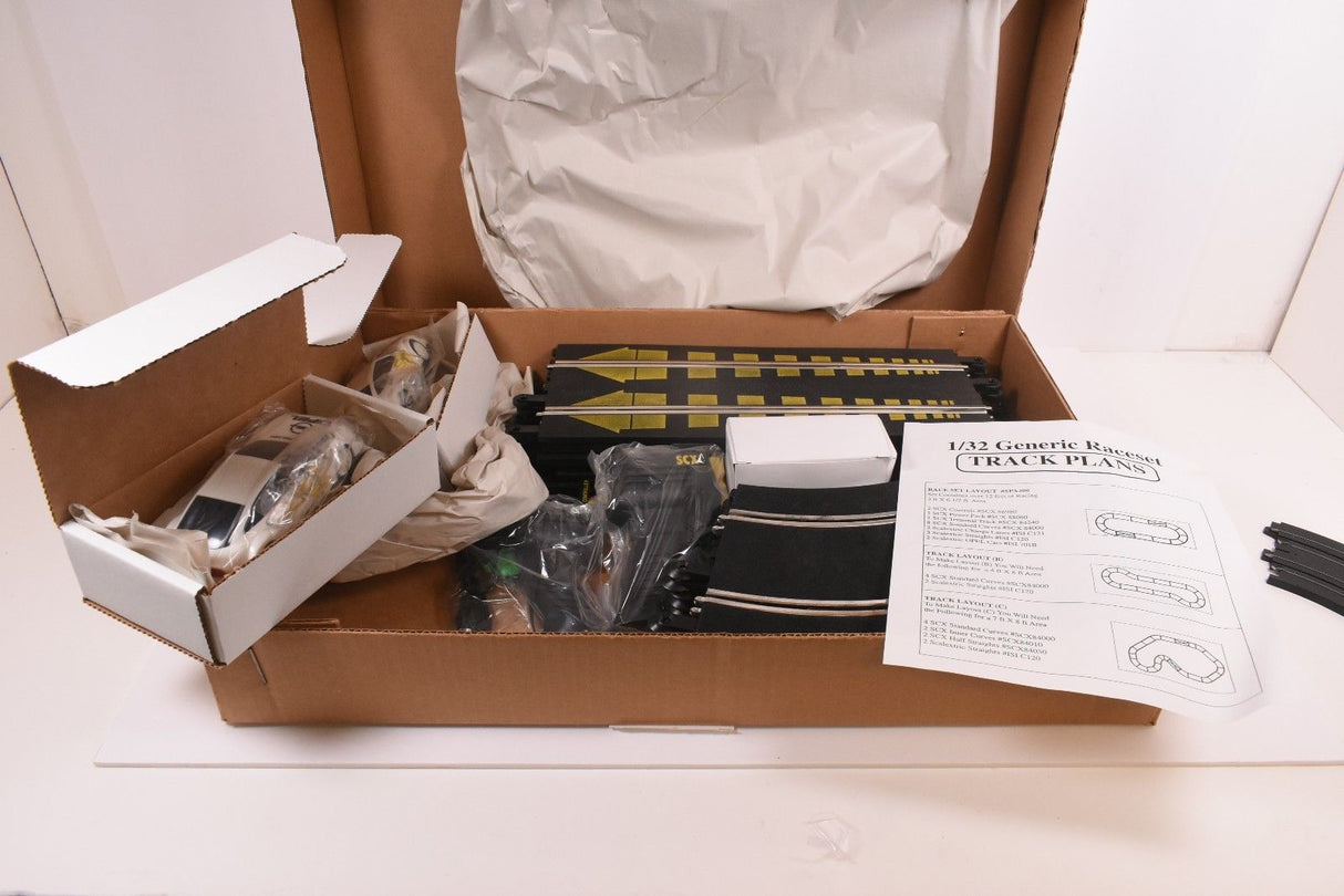Raceset contents including track plans and parts in an open box for SCX/Scalextric SPA300
