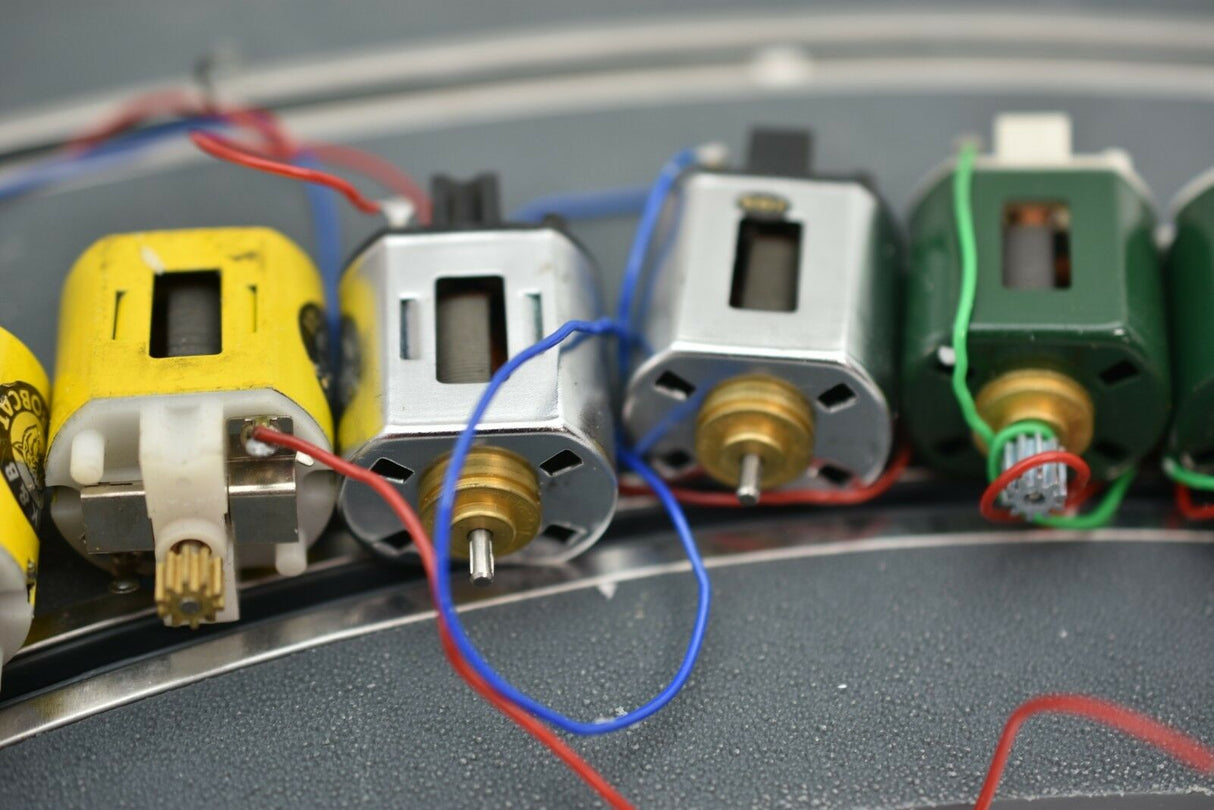 Row of small electric motors with wires connected, showing various colors for Mabuchi 8-Motors