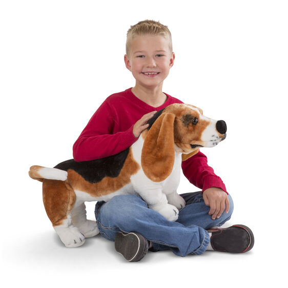 Boy with a large stuffed Basset Hound dog toy for Melissa and Doug 4866
