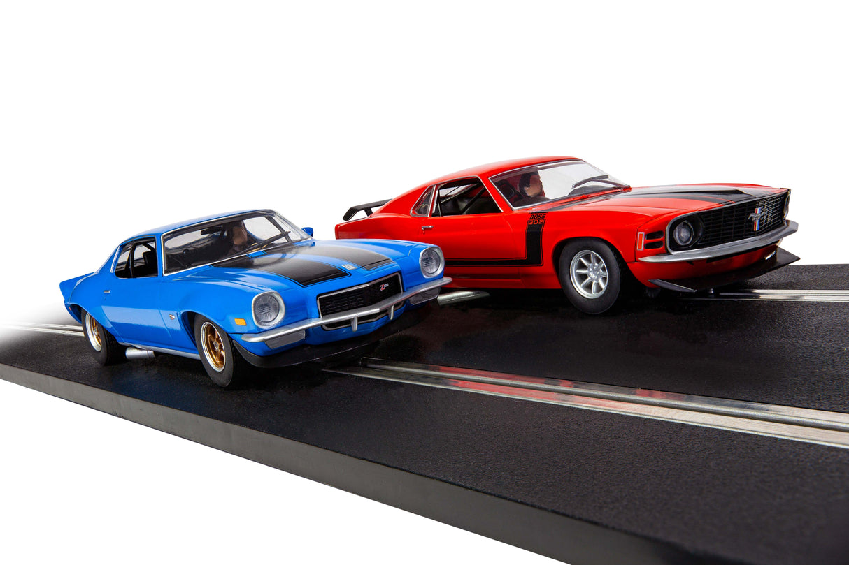 Blue and red slot car race cars on a black track for Scalextric 1/32 C1429T
