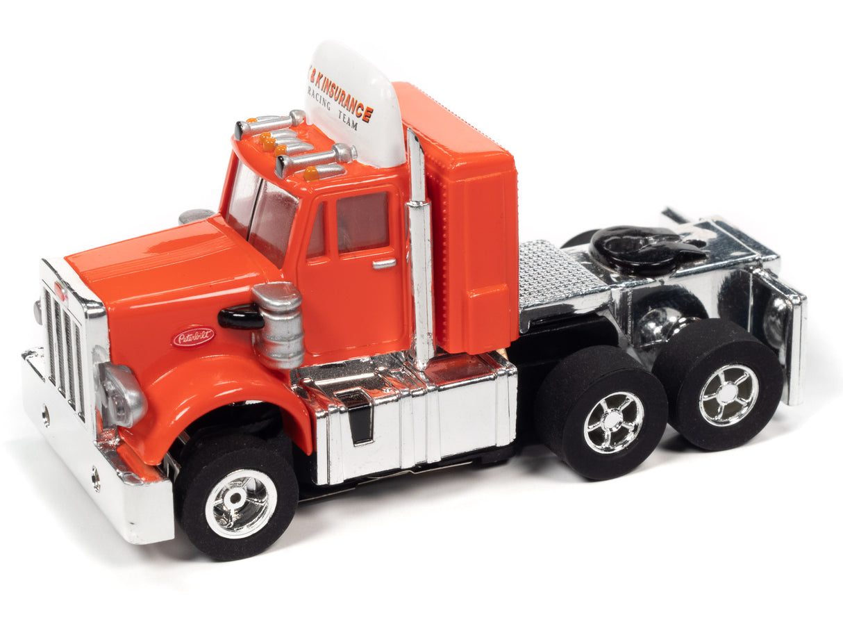 Red and silver toy race truck with trailer, representing a 1969 Dodge Daytona for Auto World CP7899