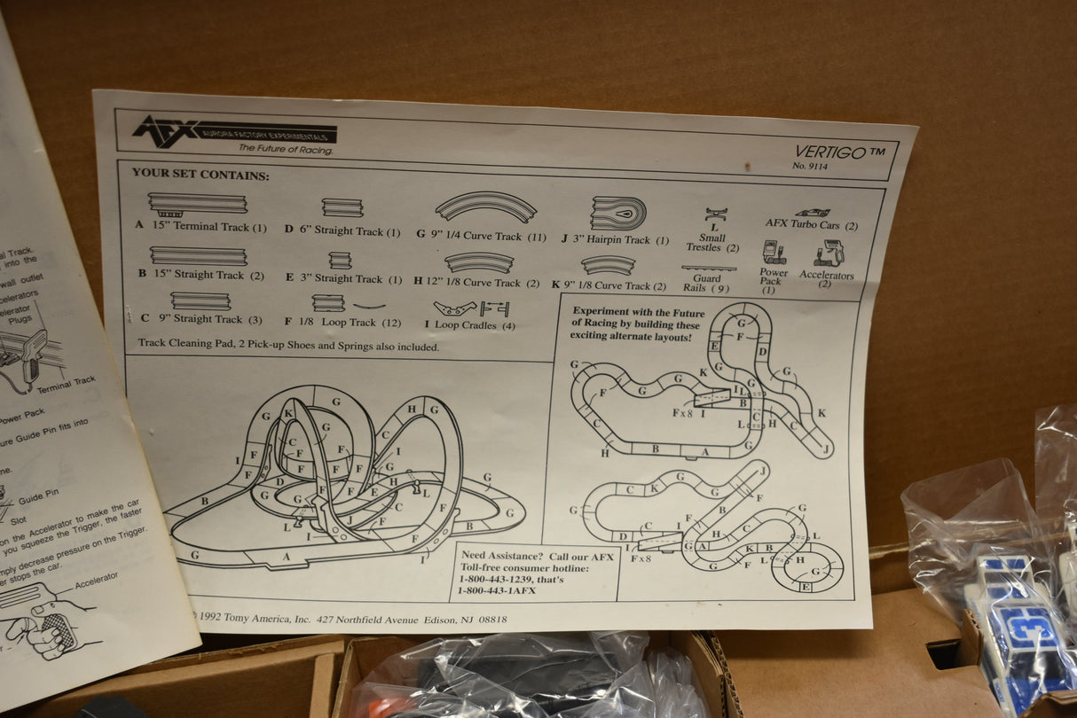 Diagram showing track layout and car components for a slot car set for Tomy AFX AURORA 9114M
