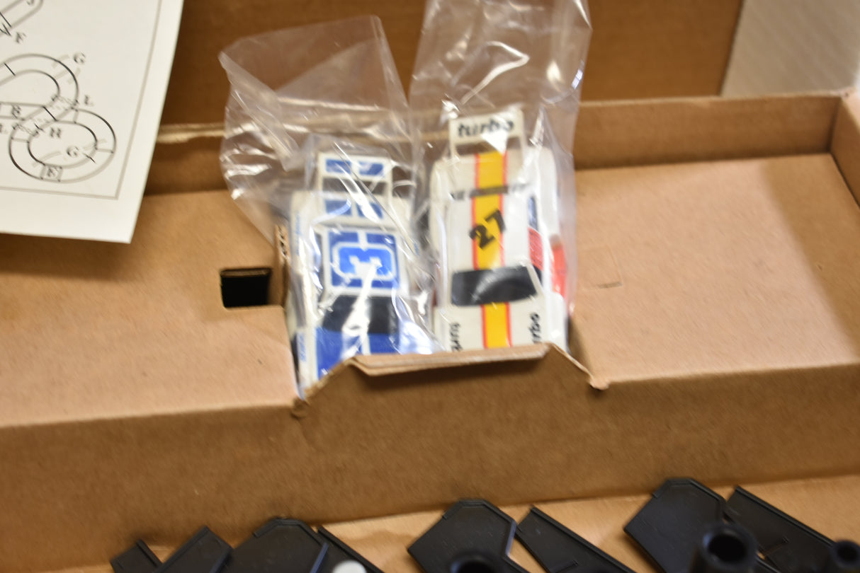 Two slot car race cars in clear plastic packaging, ready for play for Tomy AFX AURORA 9114M