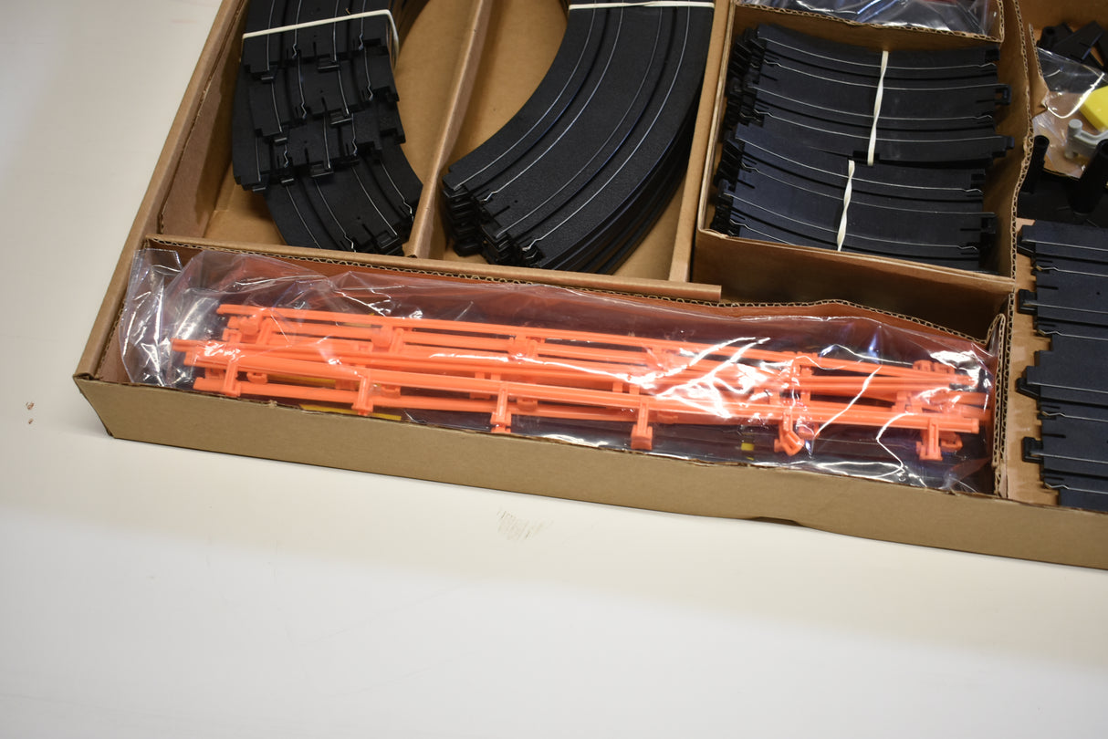 Slot car set components: black track pieces and orange car pieces for Tomy AFX AURORA 9114M