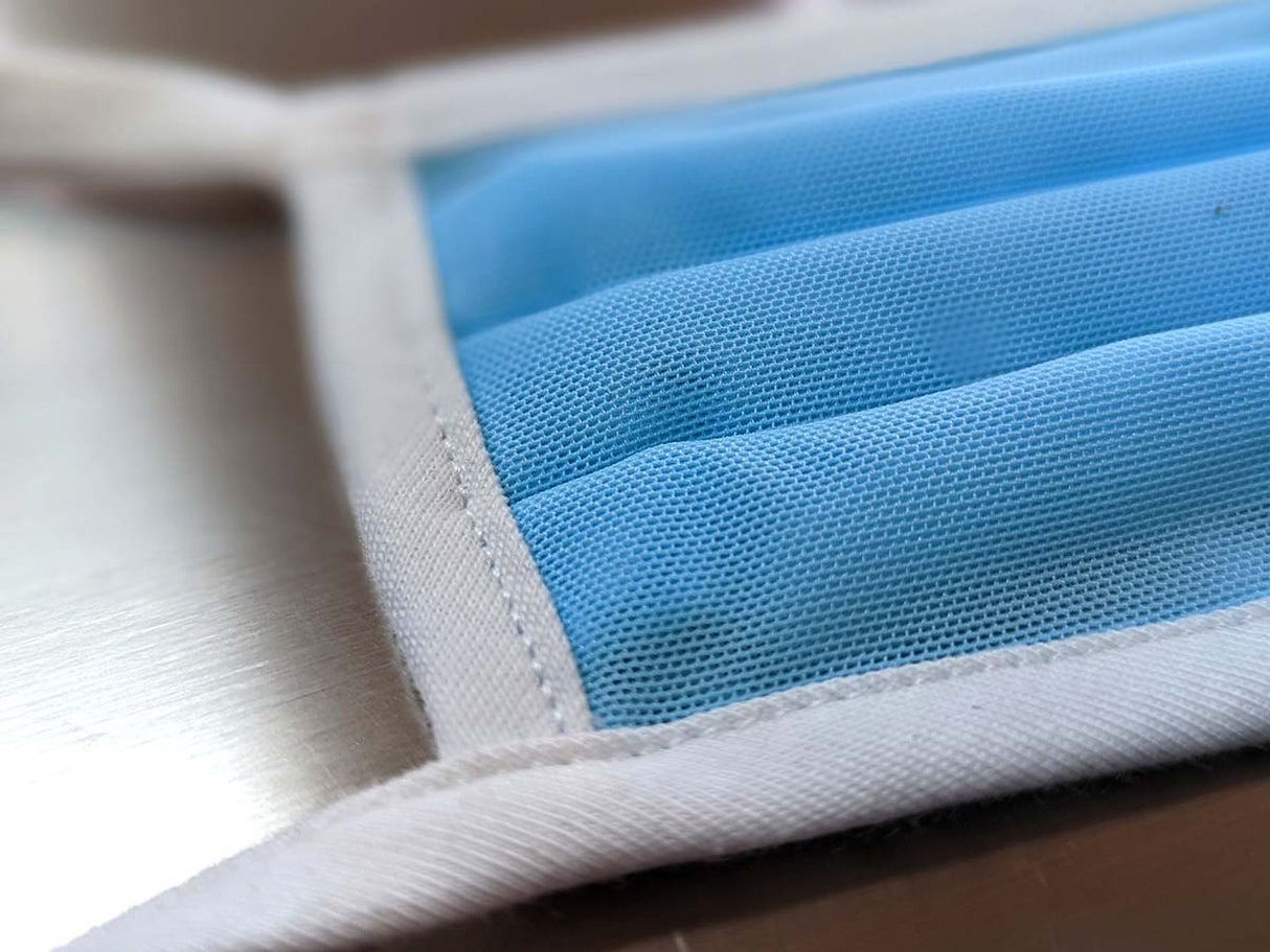 Light blue pleated face mask with white edges, showing breathable material for Fake Mask USA