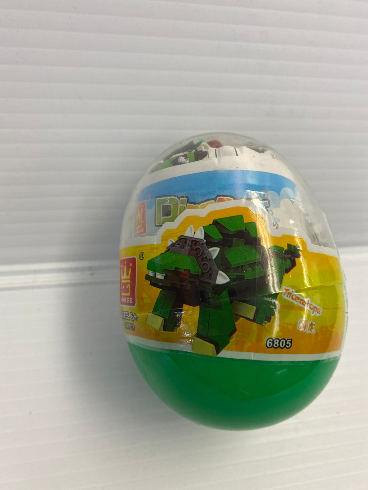 Dinosaur-themed toy egg with green base and block design for IMEX Model Company WAG68016