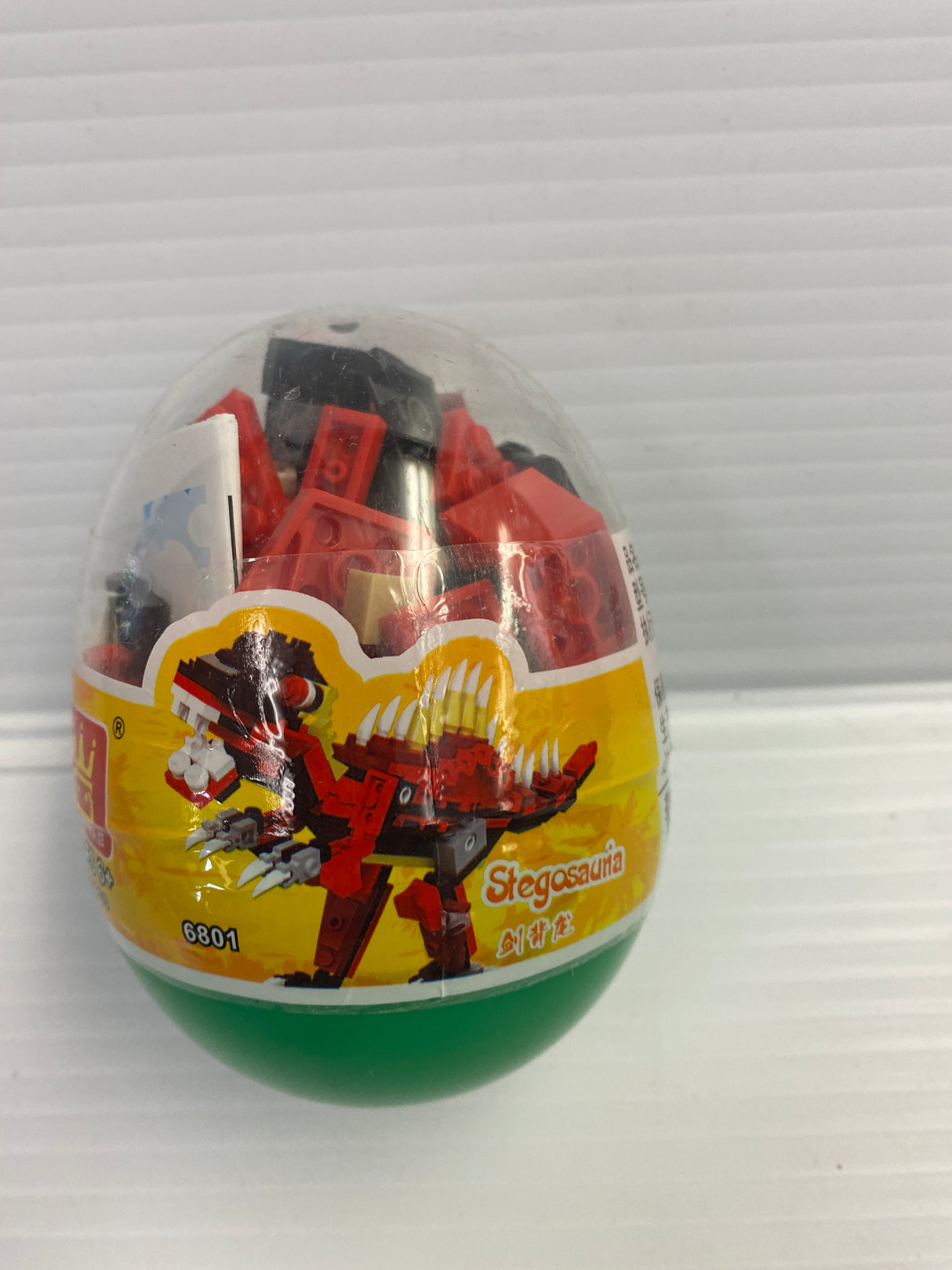 Dinosaur building block set in a clear, round container for IMEX Model Company WAG68016