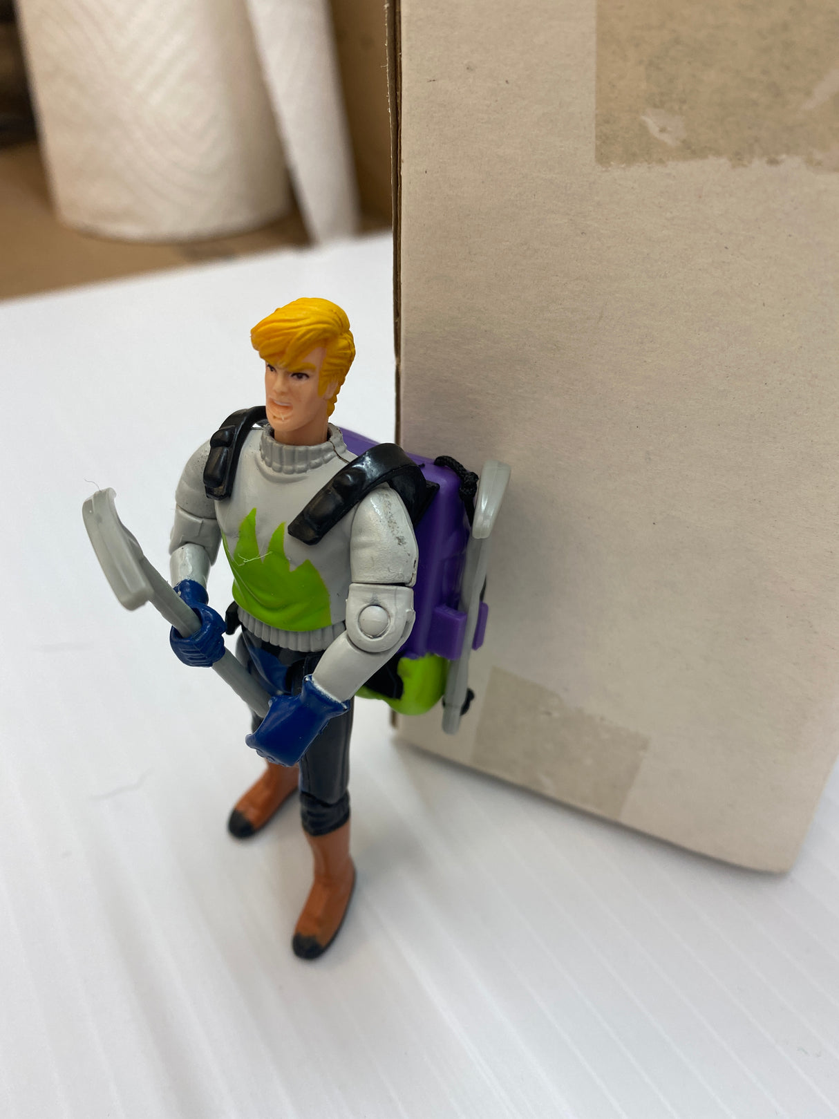 Action figure of Jonny Quest with backpack, standing near a cardboard box for Galoob 74843