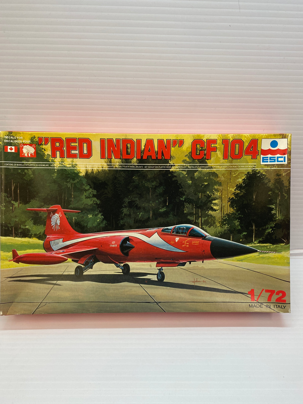 Scale model kit box art featuring a red and black "Red Indian" CF 104 aircraft for ESCI 9044