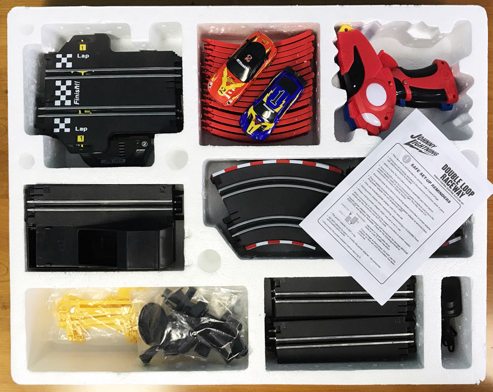 Race set components: cars, track pieces, and instructions for a slot car race for EXCLUSIVE JLRS001