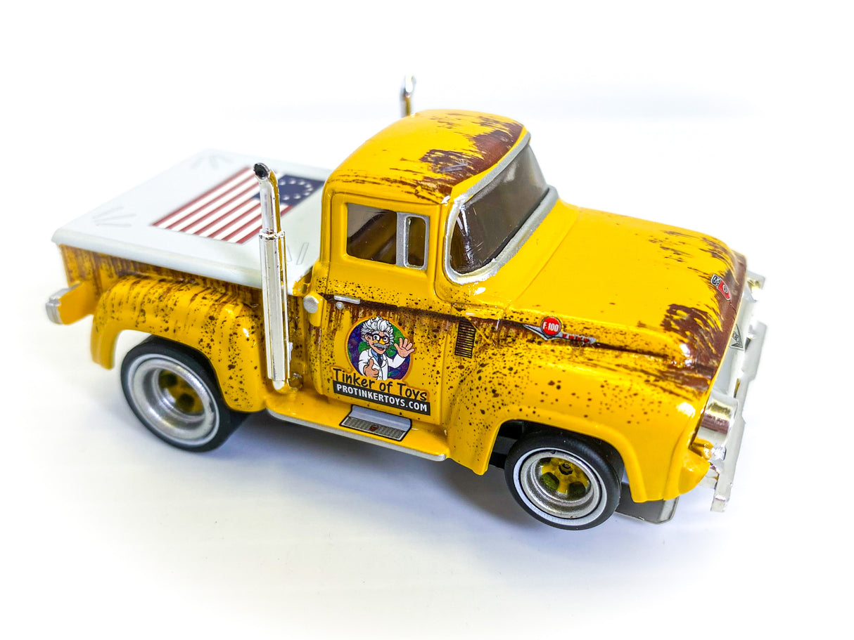 Yellow 1956 Ford F-100 pickup truck toy with white flatbed for Auto World