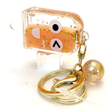 Keychain charm featuring a popsicle face design with gold-toned rings for BC Mini 12063