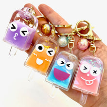 Set of colorful, cute popsicle face key charms on a hand for BC Mini 12063