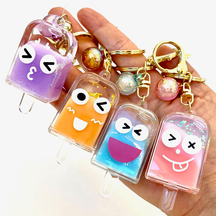 Cute, colorful popsicle face key charms on a hand for BC Mini 12063