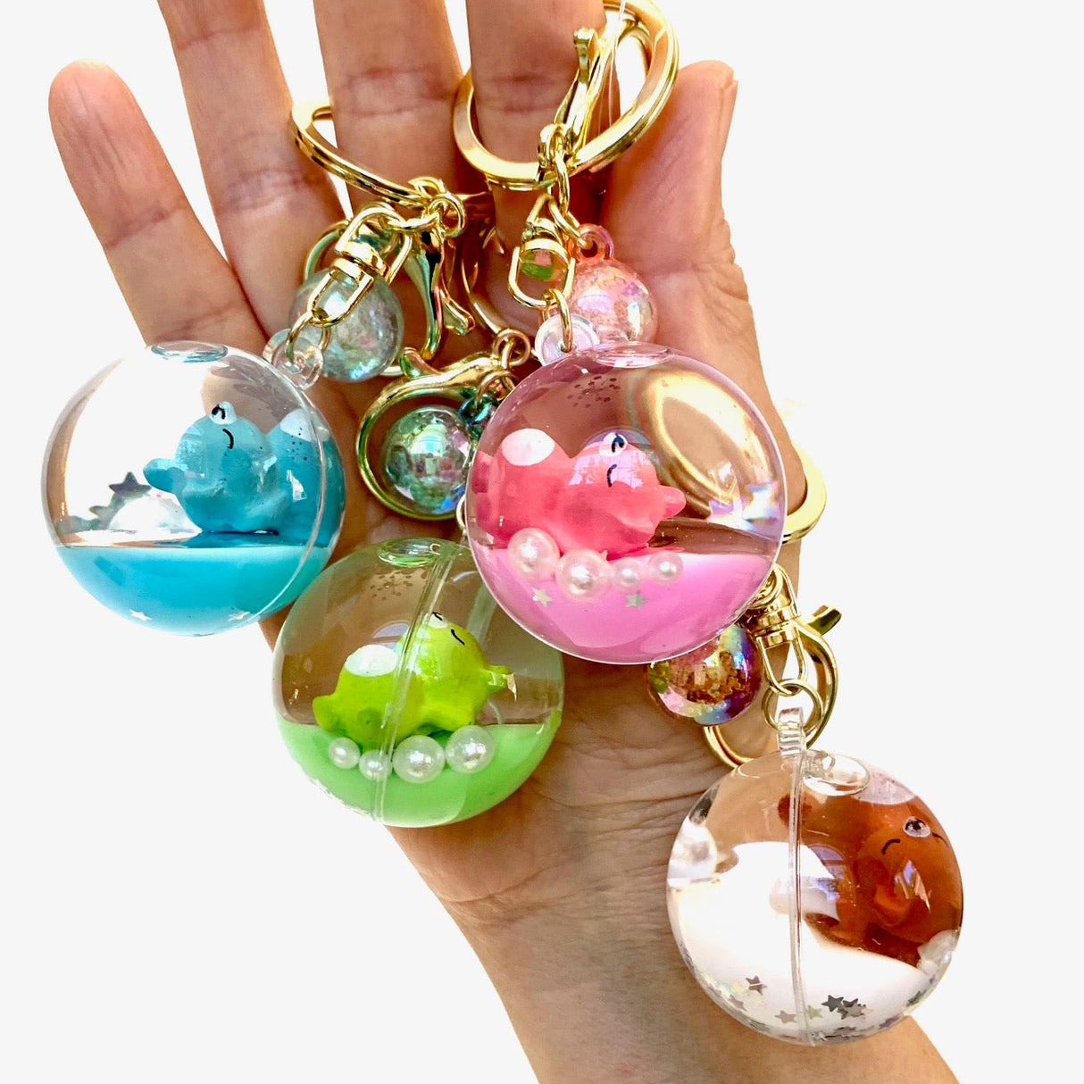 Assortment of acrylic key charms featuring sleeping animals in liquid spheres for BC Mini 12056