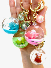 Assortment of sleeping animal ball key charms on a hand for BC Mini 12056