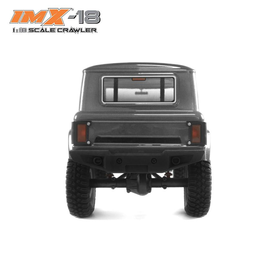 Rear view of a dark gray 1:18 scale crawler vehicle for IMX IMX25005