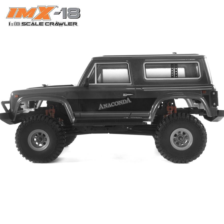 Black 1:18 scale crawler vehicle with large off-road tires for IMX IMX25005, rear view