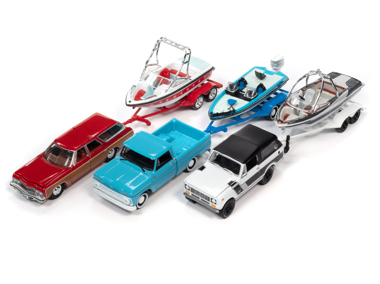 Toy collection: cars, boat trailer, and fishing boats on white background for Johnny Lightning JLBT015
