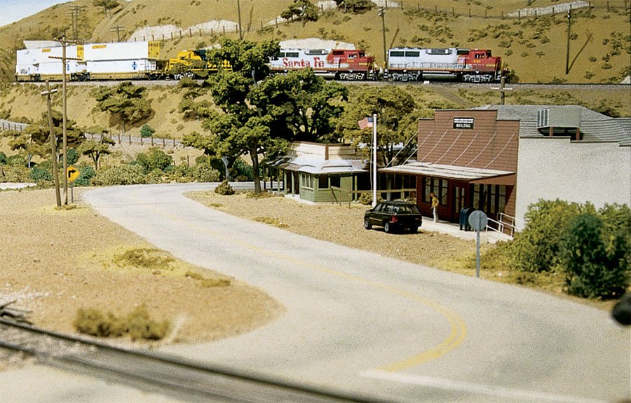 Model train set with station and curving road on a hilly landscape for WoodLand LK952