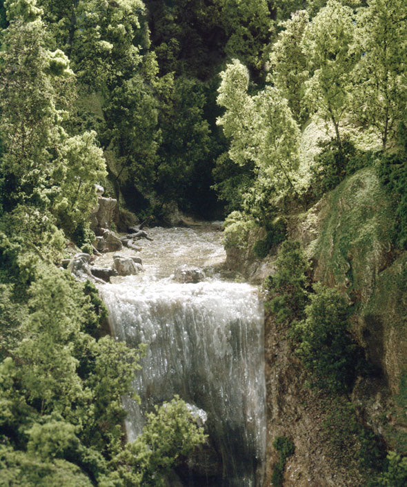 Waterfall cascading through lush, green woodland for LK955