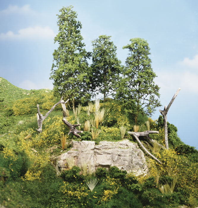 Lush green hillside with scattered trees and rocky outcrop under a bright sky for WoodLand LK956
