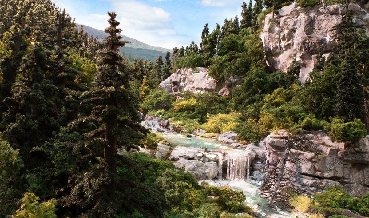 Forest waterfall cascading over mossy rocks with lush green foliage for WoodLand LK957