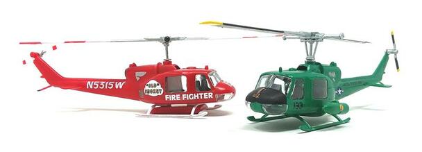 Two model helicopters: a red fire fighter and a green gunship for Atlantis Model Co ALM1026
