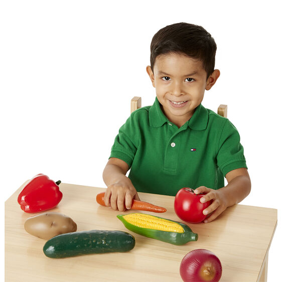 Boy with play food vegetables on a table for Melissa and Doug 4083