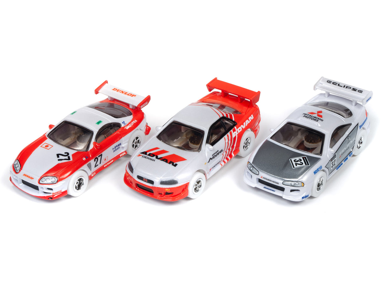 Three slot car race cars: white/red, red/white, and silver/black for Auto World SC346