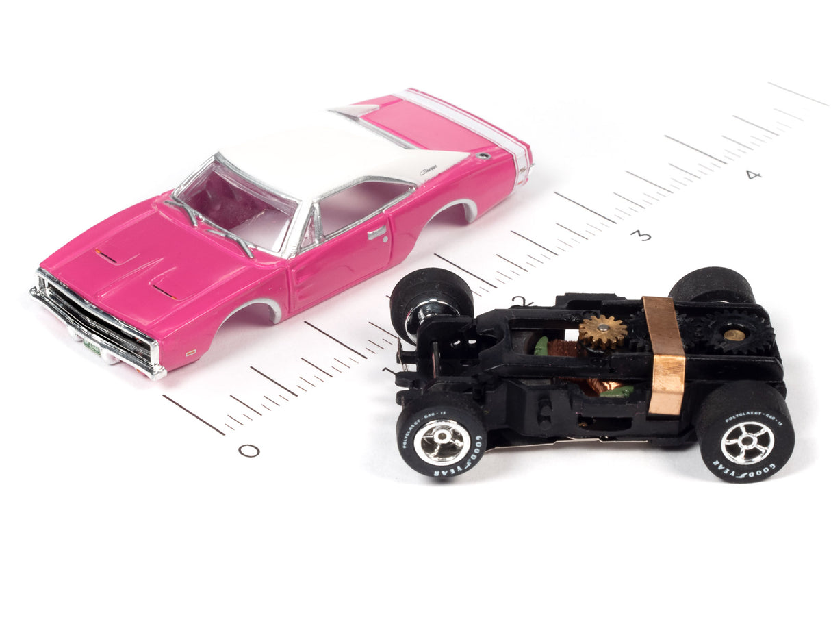 Pink slot car muscle car next to its exposed mechanical chassis for Auto World SC354